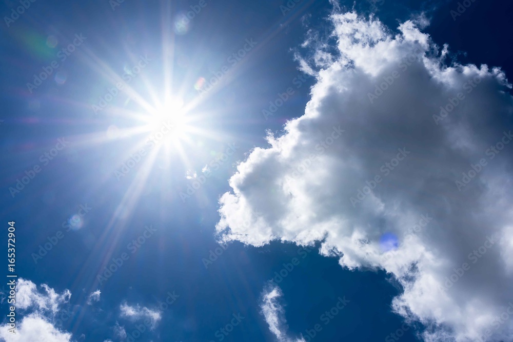 blue sky with the sun shining brightly alongside fluffy white clouds, creating a peaceful and natural outdoor scene. blue sky with the sun shining brightly alongside fluffy white clouds, creating a peaceful and natural outdoor scene.