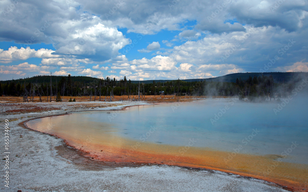 Sunset Lake under cumulus clouds in Black Sand Basin in Yellowstone National Park in Wyoming United States Sunset Lake under cumulus clouds in Black Sand Basin in Yellowstone National Park in Wyoming United States