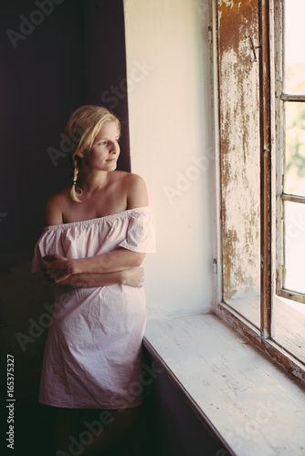 Daydreaming woman looking out window
