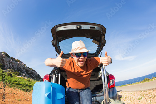 transport, leisure, road trip and people concept - happy man enjoying road trip and summer vacation.