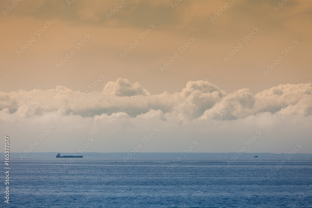Seascape, ship on sea, horizon and sky.