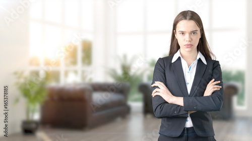 Young beautiful business woman and creative designer standing over blured interior background Free Download Young beautiful business woman and creative designer standing over blured interior background - GFXLoad
