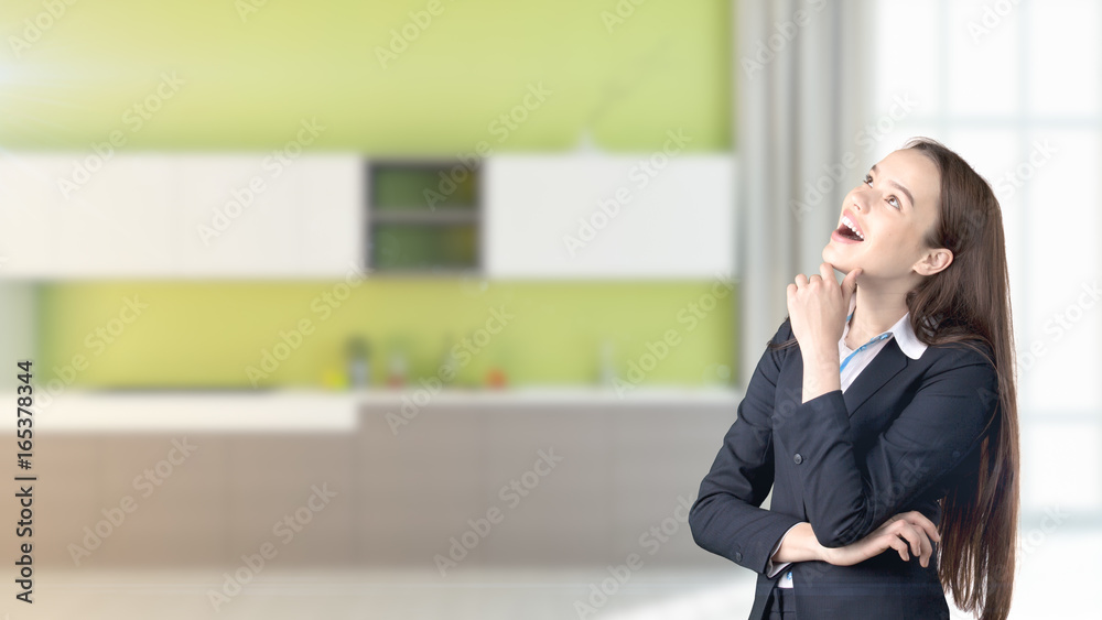 Young beautiful business woman and creative designer standing over blured interior background Young beautiful business woman and creative designer standing over blured interior background