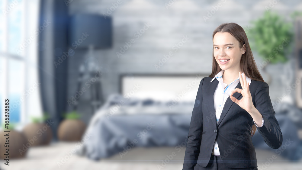 Young beautiful business woman and creative designer standing over blured interior background Young beautiful business woman and creative designer standing over blured interior background