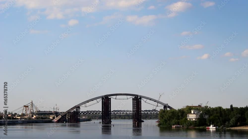 Arch of unfinished bridge across a wide river. Arch of unfinished bridge across a wide river.