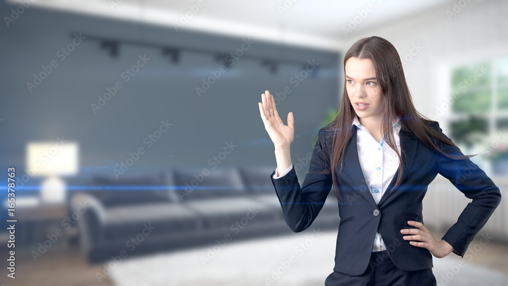 Young beautiful business woman and creative designer standing over blured interior background Young beautiful business woman and creative designer standing over blured interior background