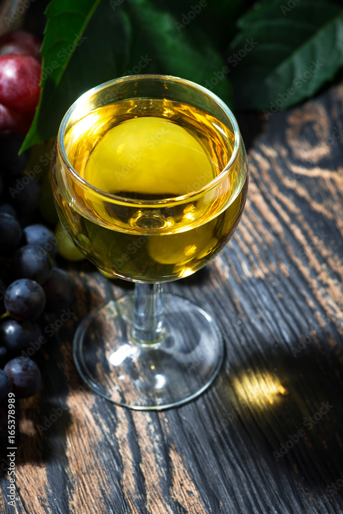 glass of white wine on wooden background, vertical glass of white wine on wooden background, vertical