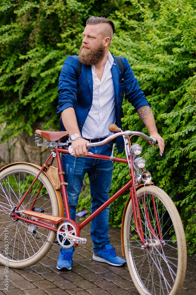 A man on a retro bicycle in a park.