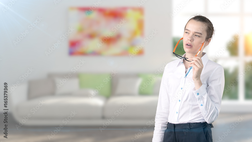Young beautiful business woman and creative designer standing over blured interior background Young beautiful business woman and creative designer standing over blured interior background
