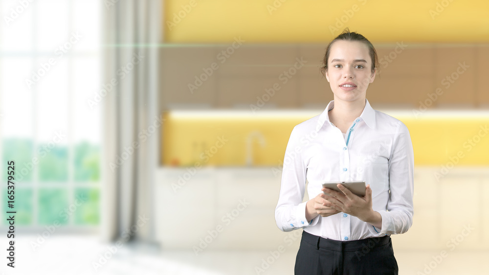 Young beautiful business woman and creative designer standing over blured interior background