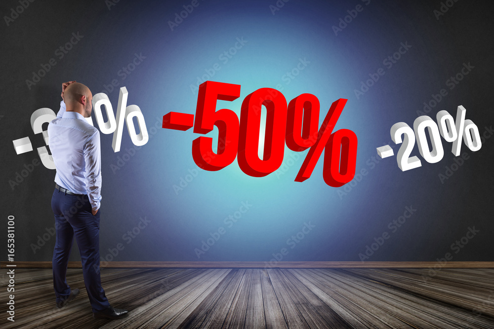 Businessman in front of a wall with sales promotion 20% 30% and 50% flying on an interface - Shopping concept Businessman in front of a wall with sales promotion 20% 30% and 50% flying on an interface - Shopping concept