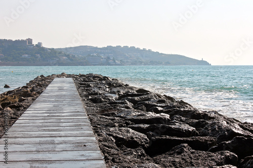 Water splashing in the rocks in Benicassim  a beach resort in the Costa del Azahar coast  province of Castello  Spain