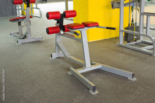 Sport, training and healthy lifestyle concept - gym interior with equipment