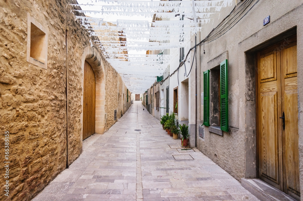 Cozy narrow street in Alcudia old town, Mallorca, Spain