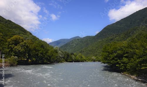 Stormy river in green mountain valley