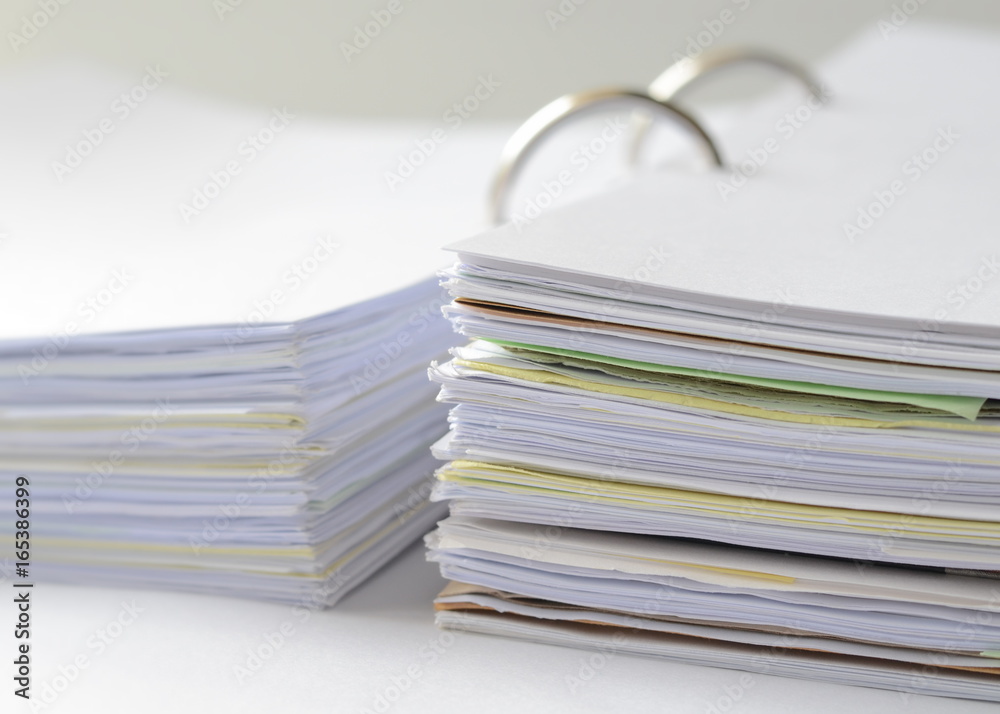 Stack of papers and business documents in document file on white table.office supplies. Stack of papers and business documents in document file on white table.office supplies.