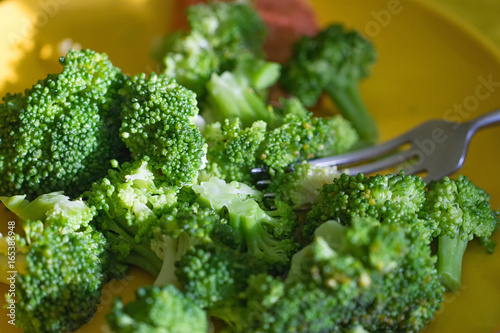 Fresh broccoli cut in yellow plate