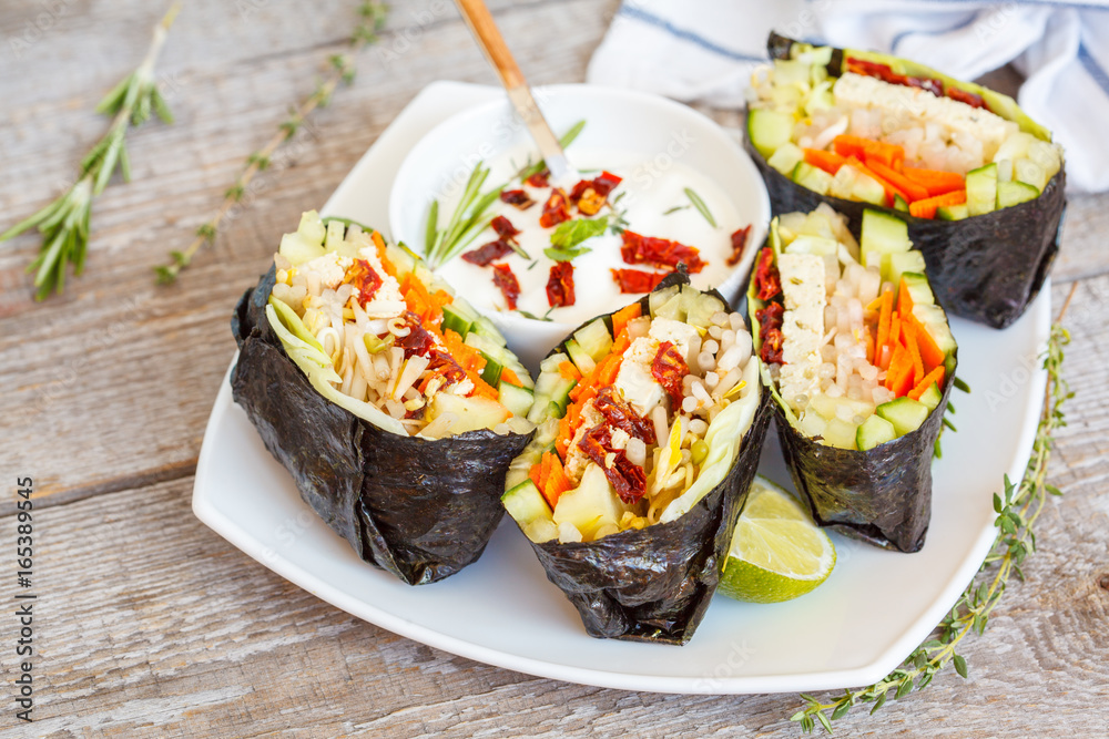 Vegan onigirazu with tofu and vegetables. Healthy vegan dinner concept. Vegan onigirazu with tofu and vegetables. Healthy vegan dinner concept.