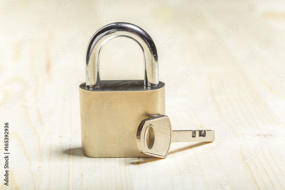 Naklejka premium check-lock on the wooden table background