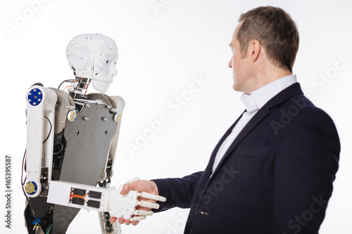 Excited determined scientist greeting the robot
