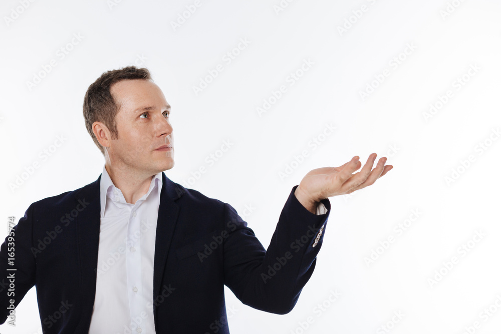 Careful mindful guy holding something in his hand Careful mindful guy holding something in his hand