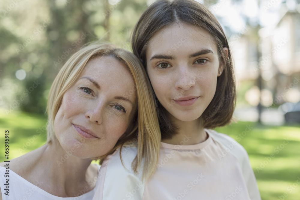 Portrait of smiling mother and daughter at park Portrait of smiling mother and daughter at park