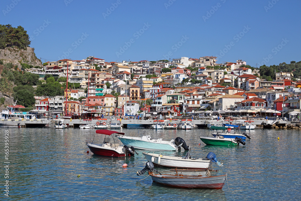 boats in port and colorful buildings Parga Greece