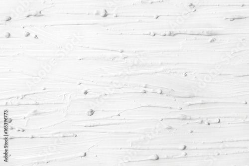Texture of white oil paint. Background is painted with a brush with a divorce.