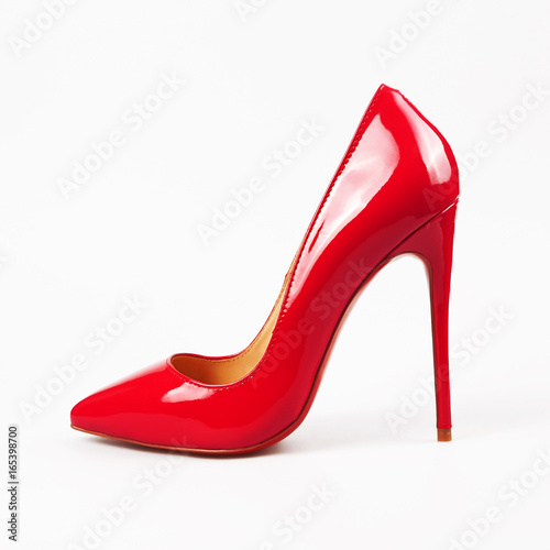 Valokuva female red high-heeled shoes over white