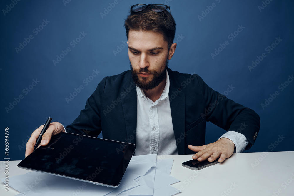 Business man with a beard working at his desk in the office, business Business man with a beard working at his desk in the office, business