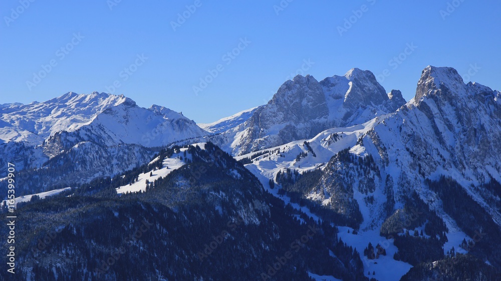 Snow covered mountains Gummfluh and Le Rubli, view from mount Rellerli.