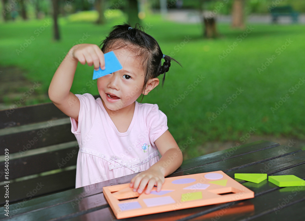 Little child girl learning shape textured foam in the garden. Little child girl learning shape textured foam in the garden.