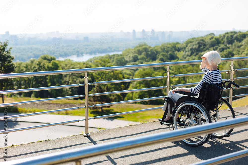 Inspired disabled lady looking at the city skyline Inspired disabled lady looking at the city skyline