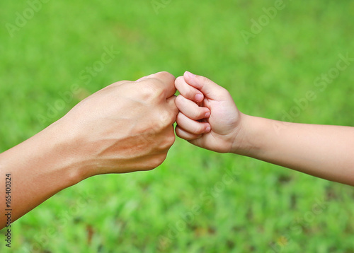 Hands of mother and daughter.