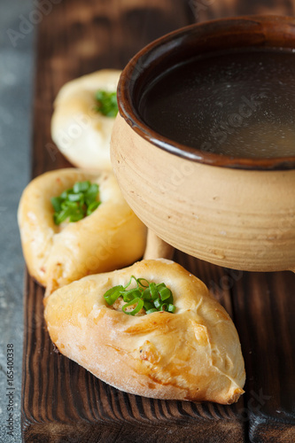 Russian patties rasstegai with fish and fish bouillon photo