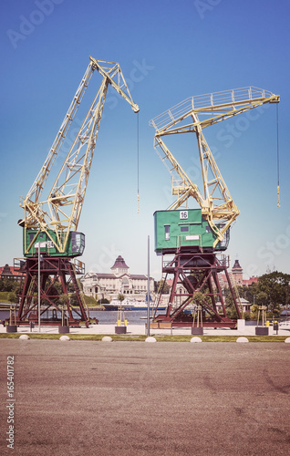 Retro stylized port cranes at Szczecin boulevards, Poland.
