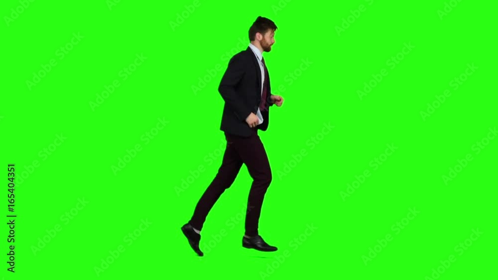 Businessman runs to work, is late for an important meeting. Green Screen. Slow motion Businessman runs to work, is late for an important meeting. Green Screen. Slow motion