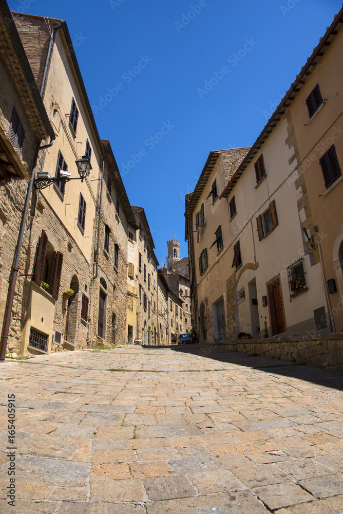 Beautiful narrow street of historic tuscan city Volterra, Italy
