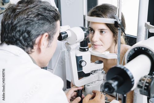 Fototapeta Naklejka Na Ścianę i Meble -  Eye Doctor examinating a young patient