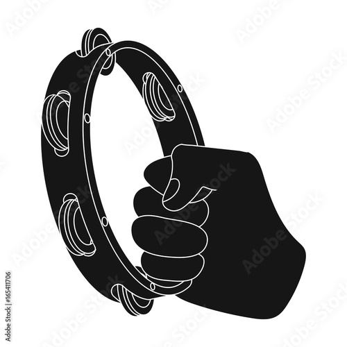 A tambourine that produces a melodic sound. Tambourine in his hand single icon in black style vector symbol stock illustration web.