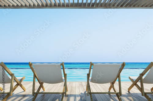 Row of white chairs near a pool © ImageFlow