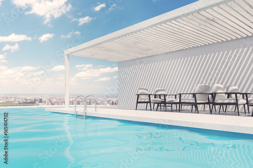 Swimming pool with white armchairs, clouds © ImageFlow
