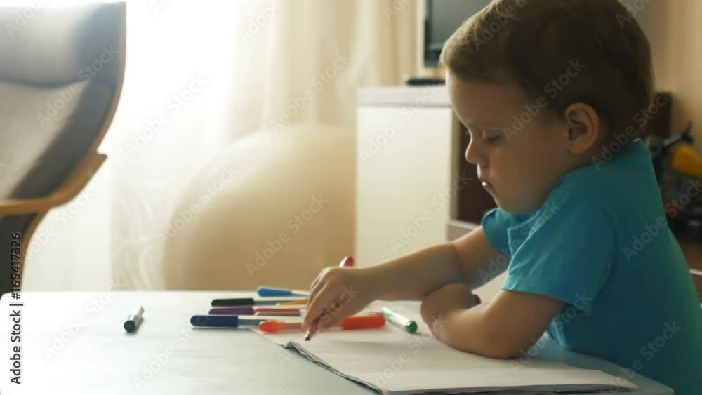 Preschool boy focused on drawing by felt-tip pen Preschool boy focused on drawing by felt-tip pen