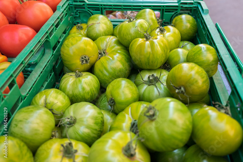 Organic fresh green tomatoes "Zebra" sold at local store in Provence region. France