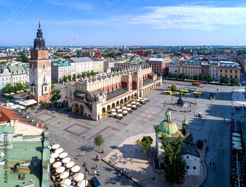 Main Market Square (Rynek), old cloth hall (Sukiennice), town hall tower, Church of St. Adalbert or St. Wojciech and renovated Mickiewicz statue in Krakow (Cracow) Poland. Aerial view