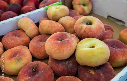 Saturn Peaches or Donut peaches sold at  local city market. Provence. France photo