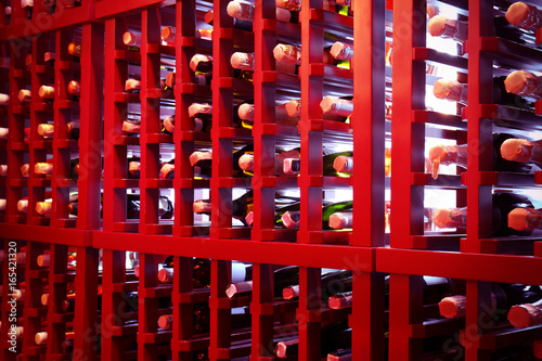 Rack with bottles of wine at store