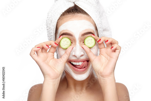 Woman in cleansing mask having fun