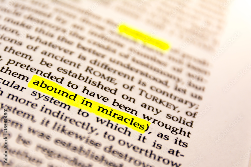 Fototapeta premium Book Highlighted Word Yellow Fluorescent Marker Paper Old Keyword Abound in Miracles