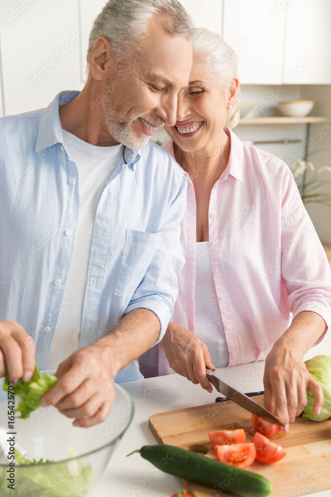 Happy mature loving couple family cooking salad Happy mature loving couple family cooking salad